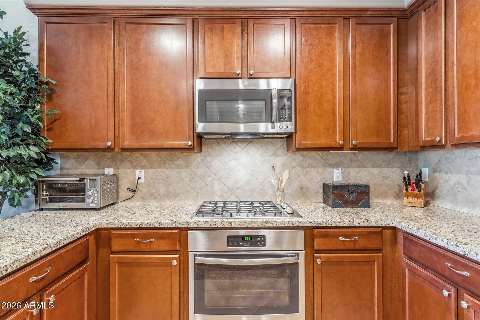 36600 North Cave Creek Road, Unit D11 Cave Creek, AZ 85331 - Photo 12 of 28 a kitchen with granite countertop wood cabinets and stainless steel appliances