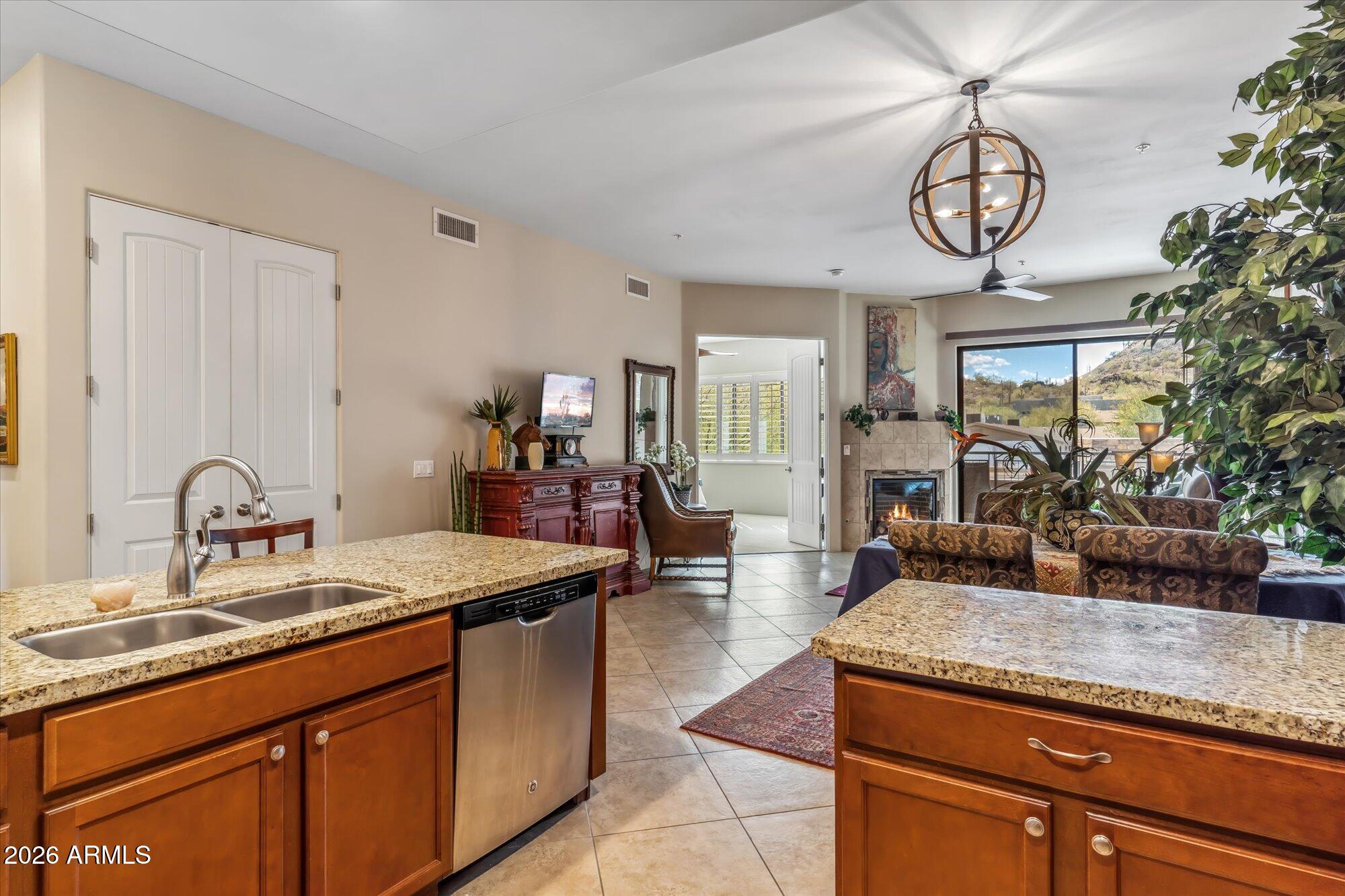 36600 North Cave Creek Road, Unit D11 Cave Creek, AZ 85331 - Photo 13 of 28 a living room with granite countertop furniture a fireplace a chandelier and mirrors