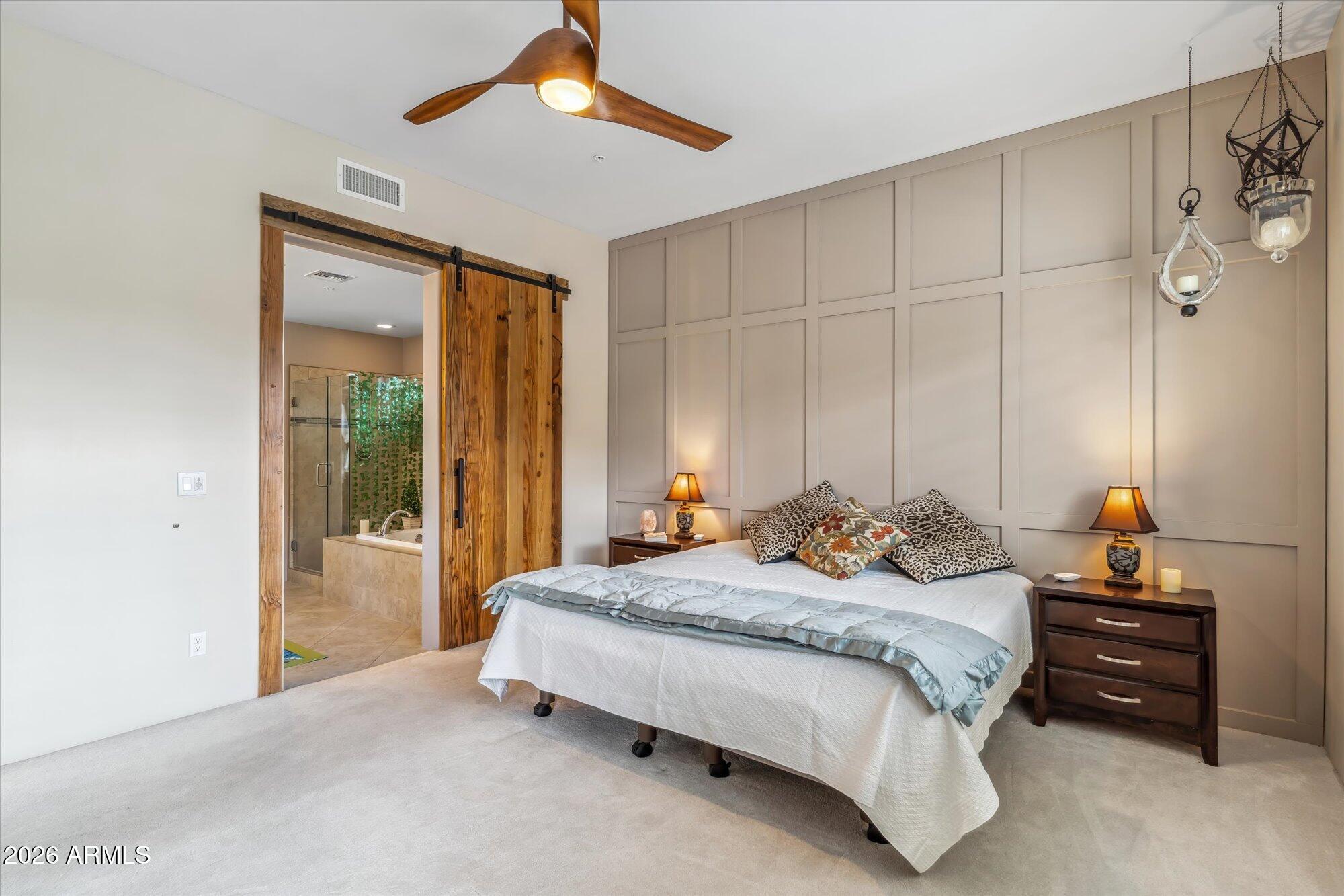 36600 North Cave Creek Road, Unit D11 Cave Creek, AZ 85331 - Photo 15 of 28 a bedroom with a bed and a chandelier