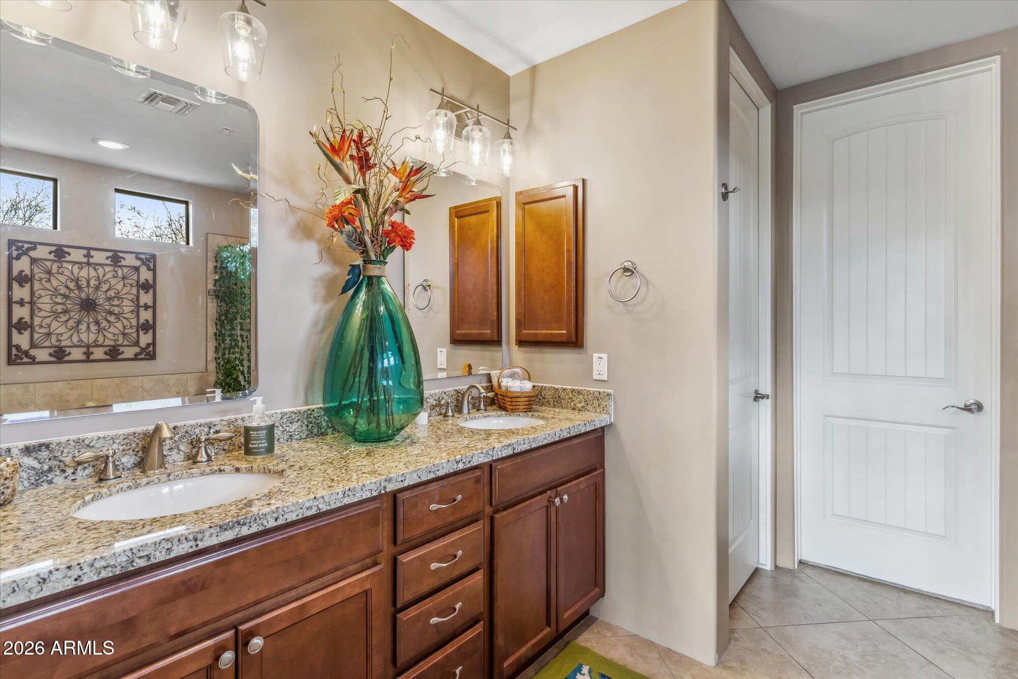 36600 North Cave Creek Road, Unit D11 Cave Creek, AZ 85331 - Photo 17 of 28 a bathroom with a granite countertop sink a mirror and a shower
