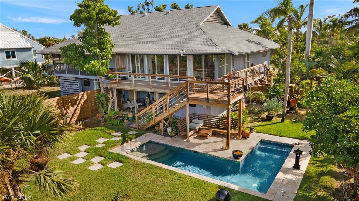 771 Rabbit Road Sanibel, FL 33957 - Photo 1 of 39 a view of a house with swimming pool