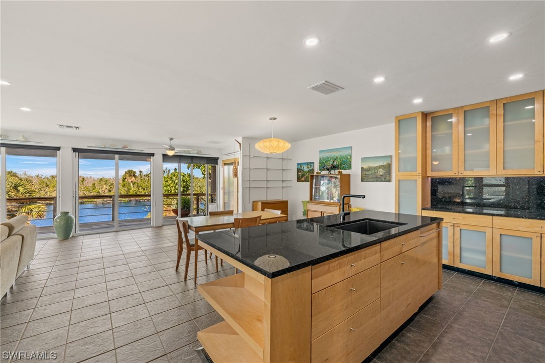 771 Rabbit Road Sanibel, FL 33957 - Photo 11 of 39 a kitchen with stainless steel appliances granite countertop a sink and a counter space