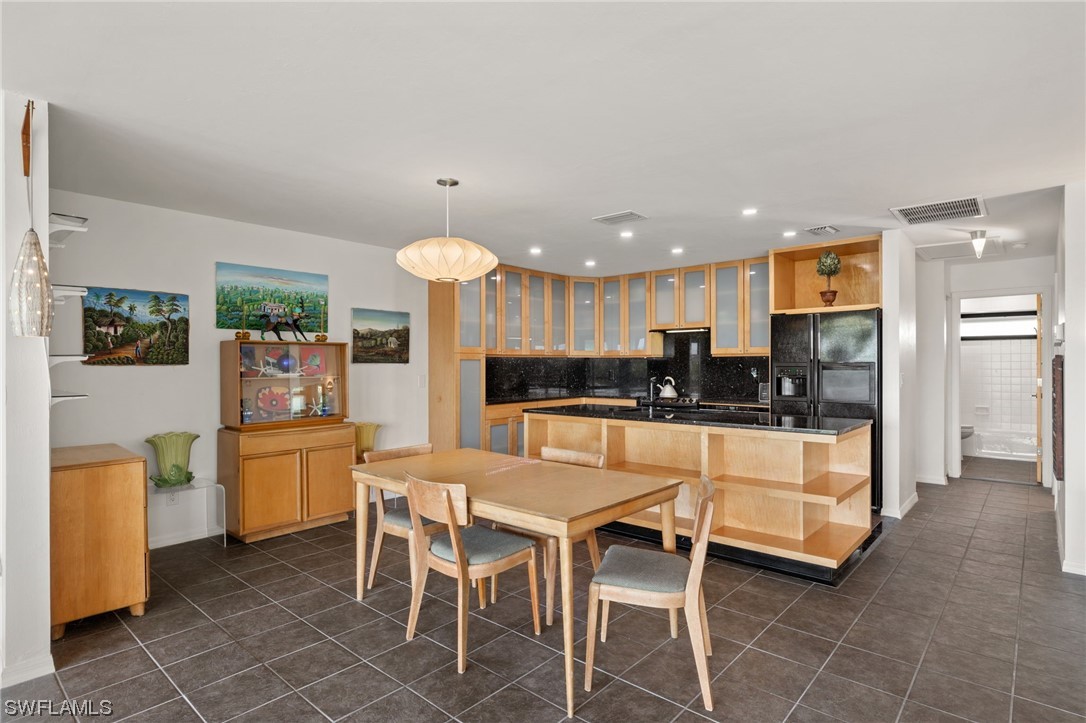771 Rabbit Road Sanibel, FL 33957 - Photo 13 of 39 a kitchen with stainless steel appliances kitchen island granite countertop a refrigerator and a stove top oven