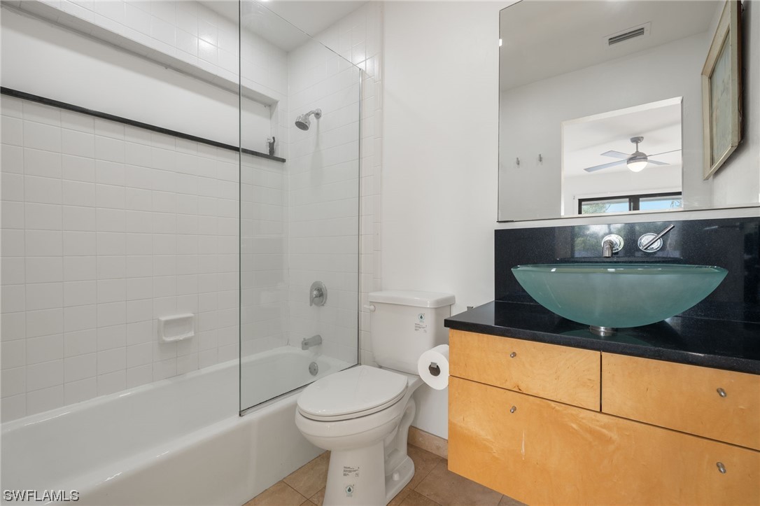771 Rabbit Road Sanibel, FL 33957 - Photo 17 of 39 a bathroom with a granite countertop sink a toilet and bathtub