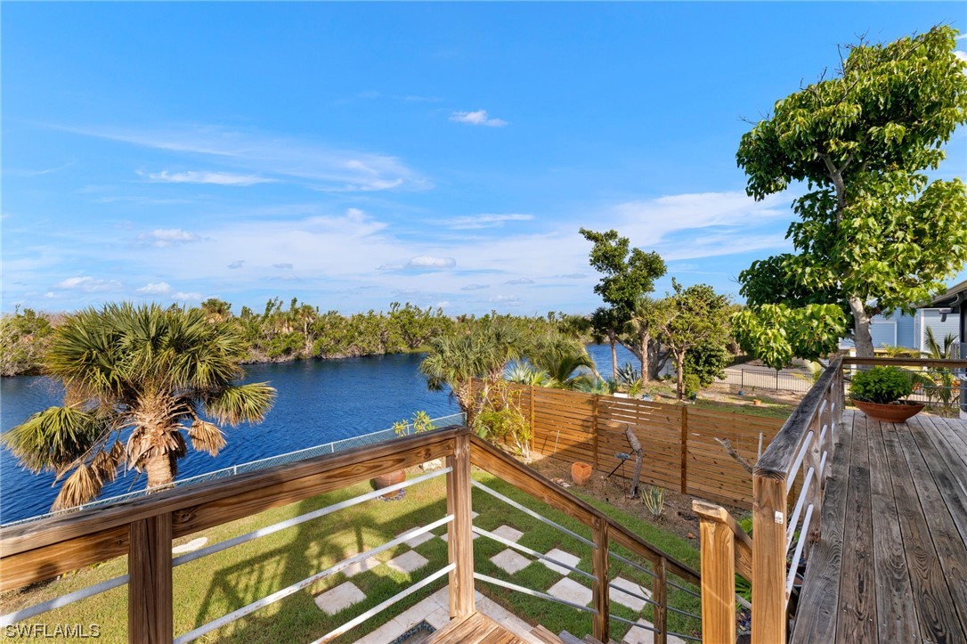 771 Rabbit Road Sanibel, FL 33957 - Photo 20 of 39 a view of a balcony with wooden floor and a potted plant