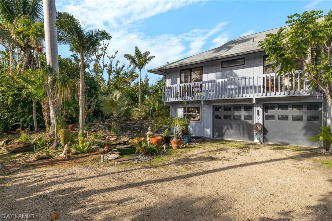 771 Rabbit Road Sanibel, FL 33957 - Photo 2 of 39 a view of a house with a patio and a yard