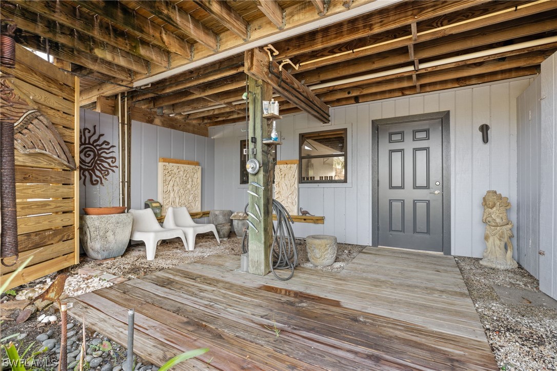 771 Rabbit Road Sanibel, FL 33957 - Photo 24 of 39 a bedroom with a bed and a chandelier