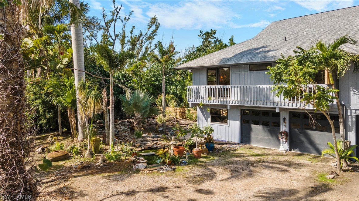 771 Rabbit Road Sanibel, FL 33957 - Photo 32 of 39 a front view of a house with garden