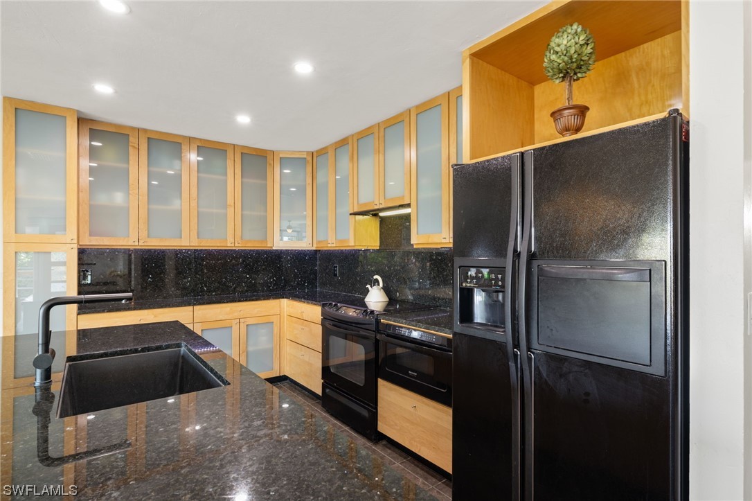 771 Rabbit Road Sanibel, FL 33957 - Photo 8 of 39 a kitchen with a refrigerator and a sink