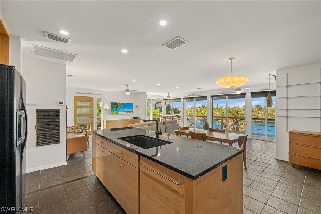 771 Rabbit Road Sanibel, FL 33957 - Photo 10 of 39 a kitchen with stainless steel appliances granite countertop a sink and a refrigerator