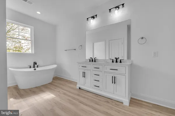 a bathroom with a shower sink and mirror