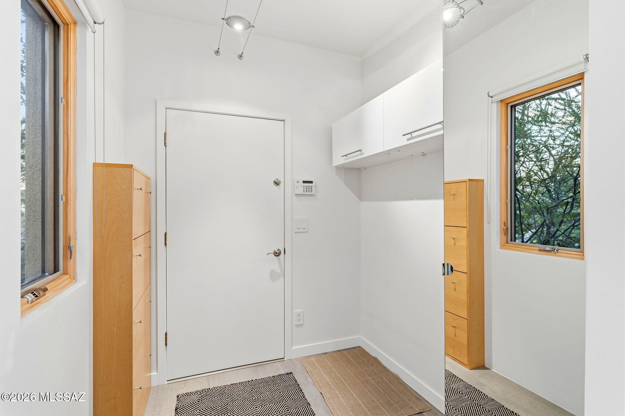 5070 North Valley View Road Tucson, AZ 85718 - Photo 47 of 51 a view of walk in closet with window and wooden floor