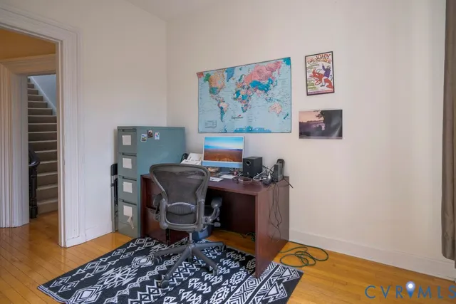 a view of a workspace with furniture and wooden floor