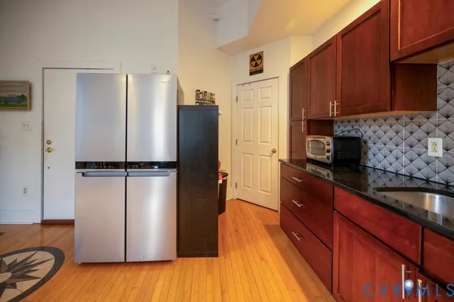 a kitchen with a refrigerator and a sink