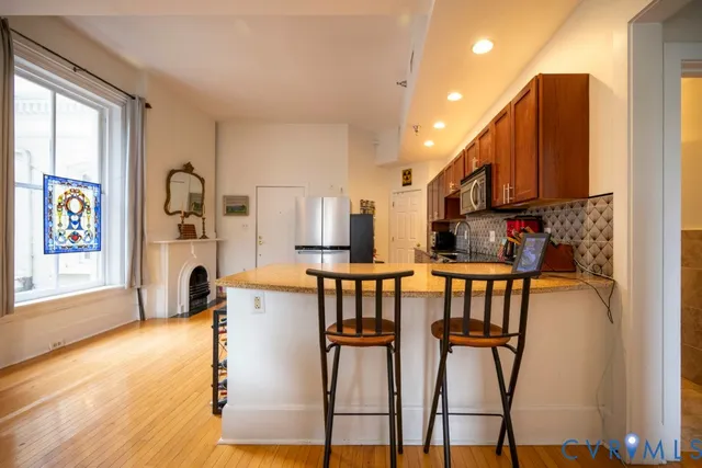 a kitchen with stainless steel appliances granite countertop a refrigerator and microwave