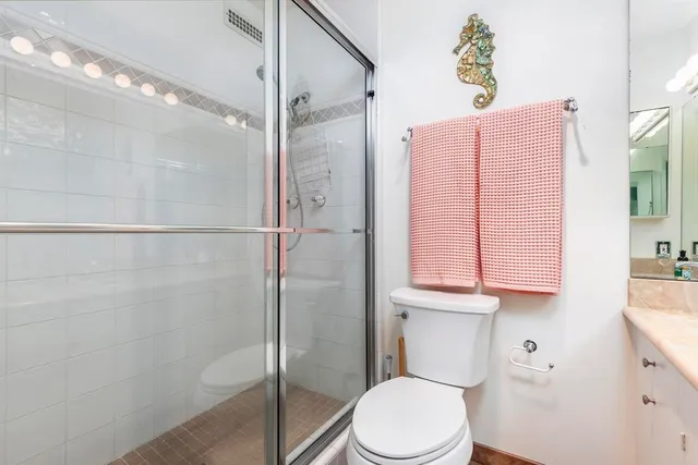 a bathroom with a toilet sink and shower