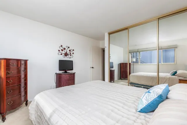 a bedroom with a large bed and a tv