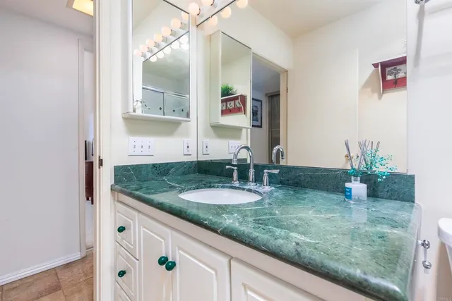 a bathroom with sink and mirror