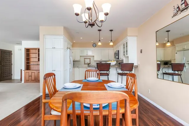 a dining room with furniture and chandelier