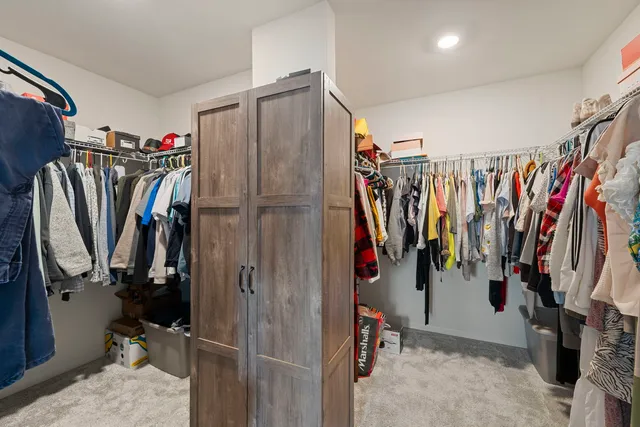 a view of walk in closet with clothes