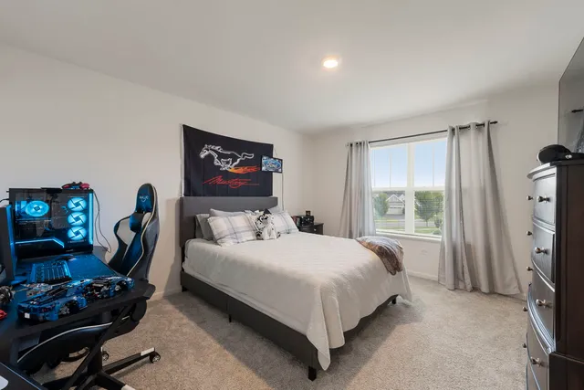 a bedroom with a bed a couch and a window