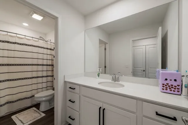 a bathroom with a shower sink vanity and mirror