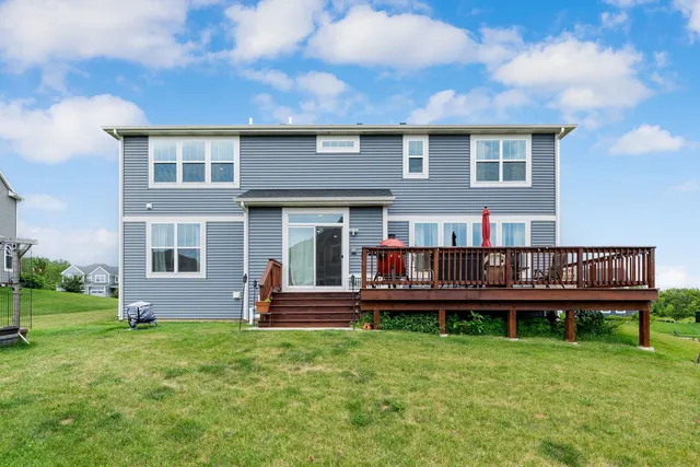 a backyard of a house with yard and trampoline