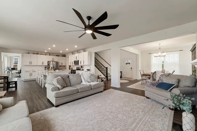 a living room with furniture and a view of kitchen
