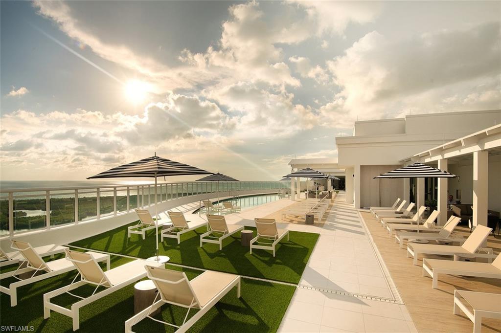 13925 Old Coast Road, Unit 506 Naples, FL 34110 - Photo 1 of 1 a view of a patio with couches chairs and wooden floor