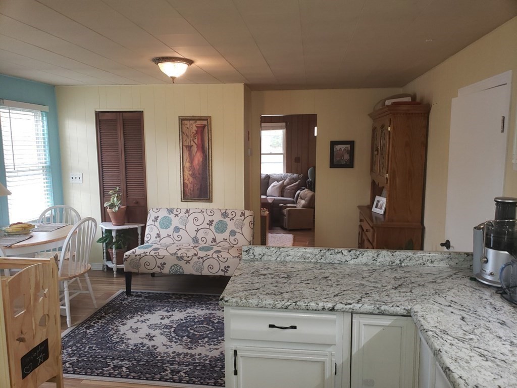 301 State Road Templeton, MA 01436 - Photo 8 of 18 a living room with granite countertop furniture a rug and a large window