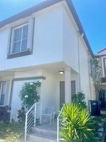 a house with a plant in front of it