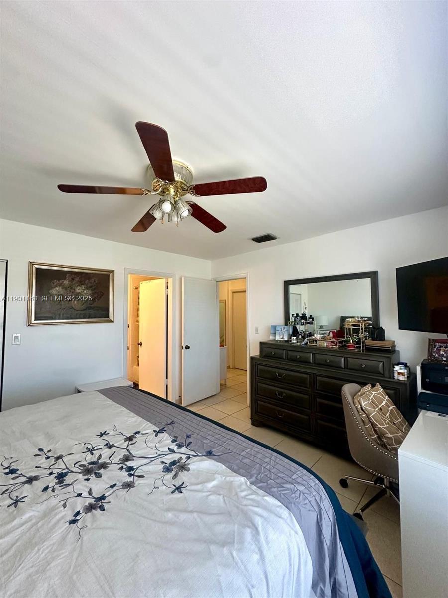 12306 Northwest 11th Street, Unit 1404 Miami, FL 33182 - Photo 14 of 31 a bedroom with a bed and a dresser