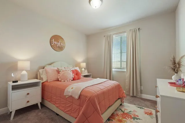 a bedroom with a bed and a potted plant