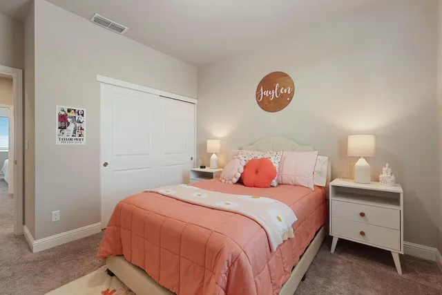 a bedroom with a bed and a lamp