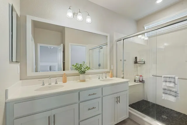 a bathroom with a double vanity sink mirror and double