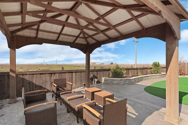 a view of a roof deck with couches and wooden floor