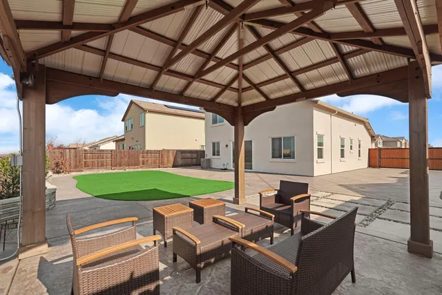 a backyard of a house with outdoor seating