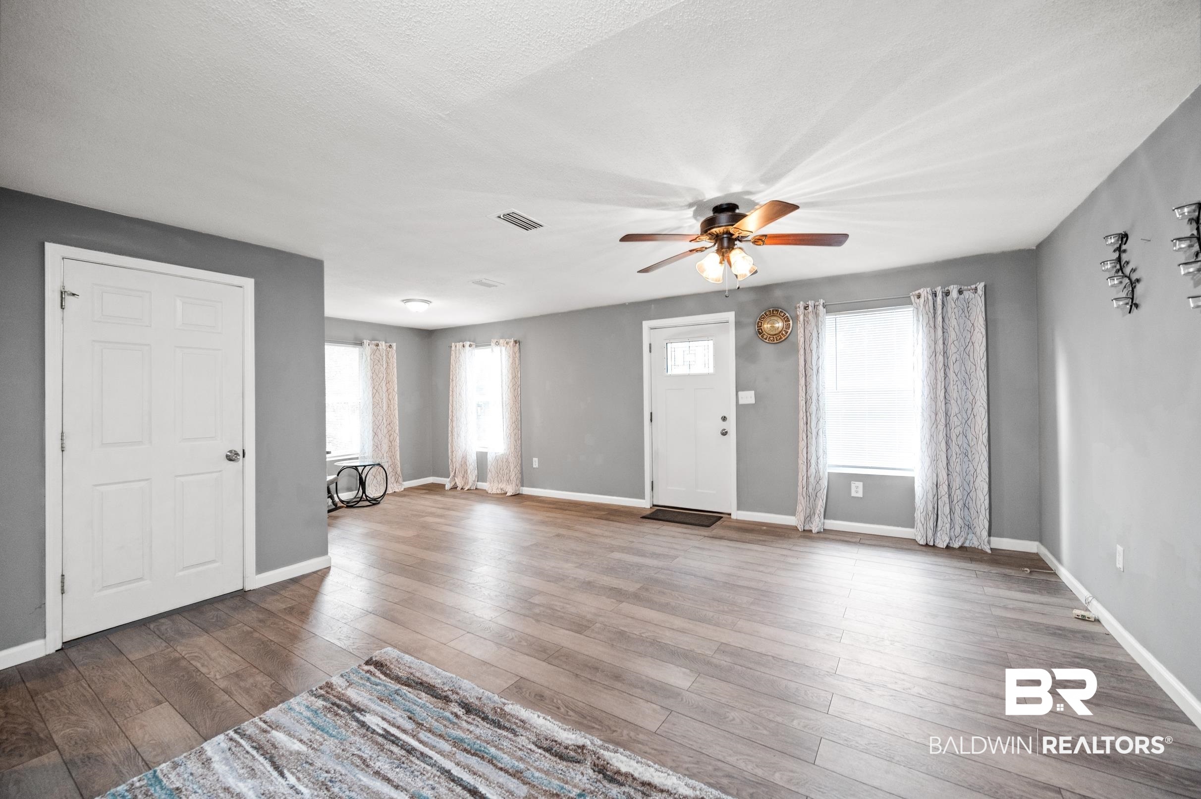 906 North Cedar Street Foley, AL 36535 - Photo 3 of 24 Entryway with dark wood-type flooring, a textured ceiling, and ceiling fan