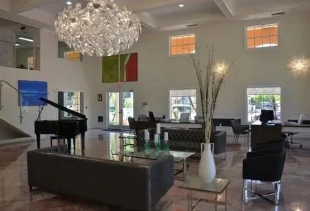 a living room with fireplace furniture and a chandelier