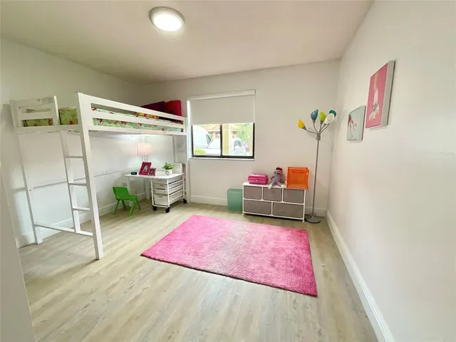a bedroom with furniture and a wooden floor