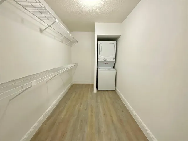 a view of a hallway with wooden floor and entryway