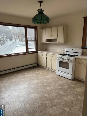 a kitchen with a stove a sink and a granite counter top