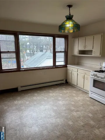 a view of a kitchen with a stove cabinets and a large window