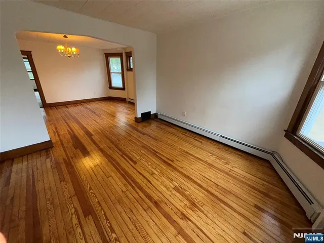 a view of an empty room and wooden floor