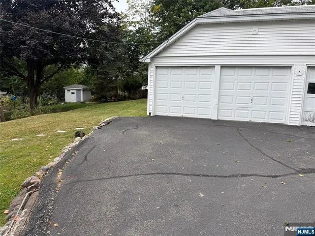 a view of a house with a yard and garage