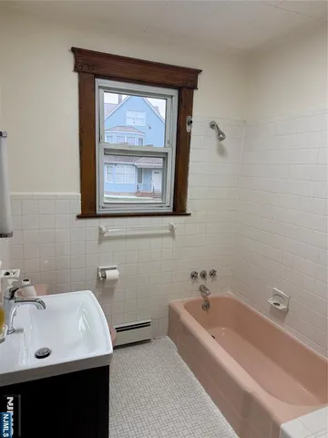 a bath tub sitting next to a white sink