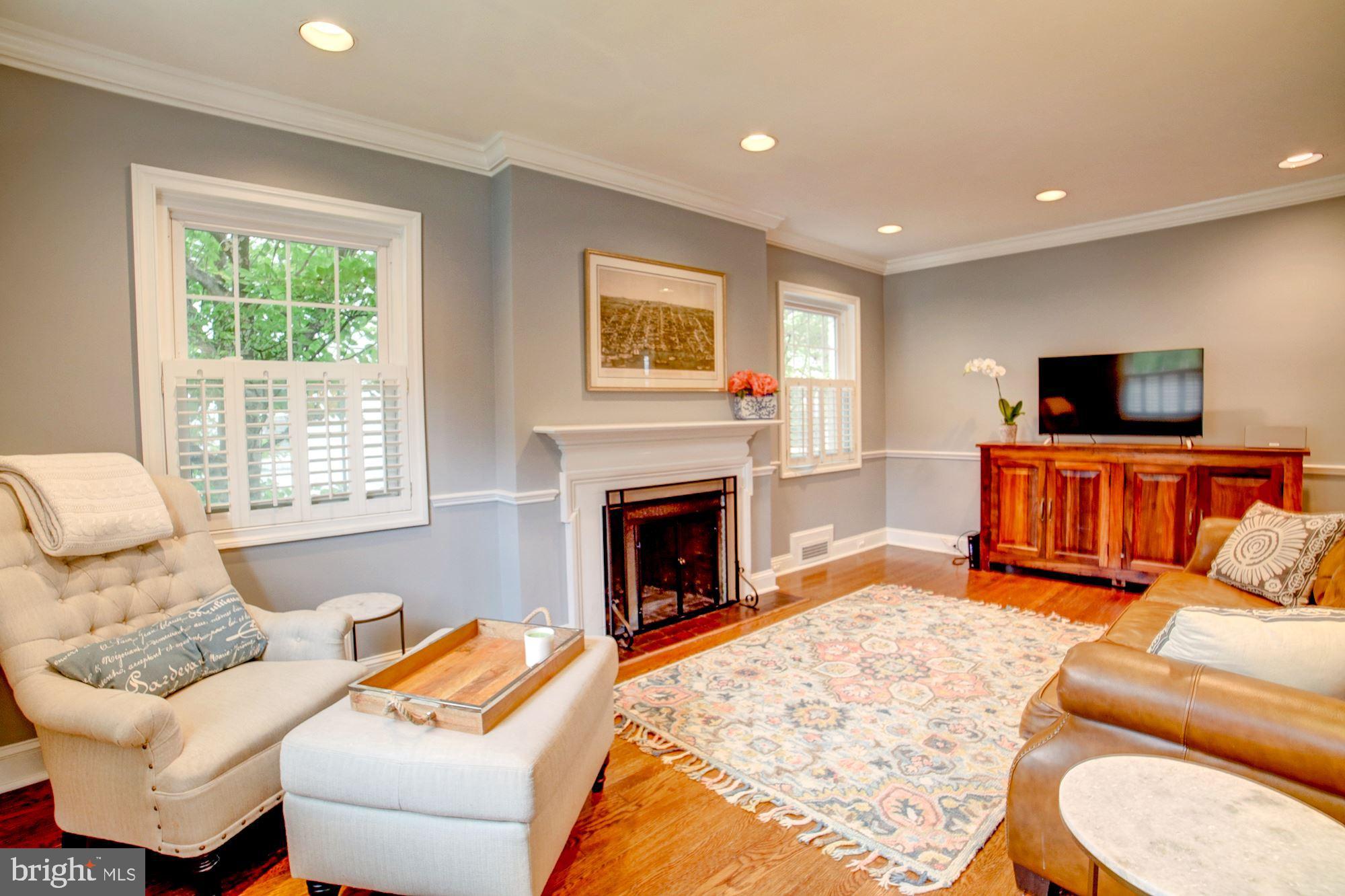 Living rm w/wood-burning fireplace & wood floors