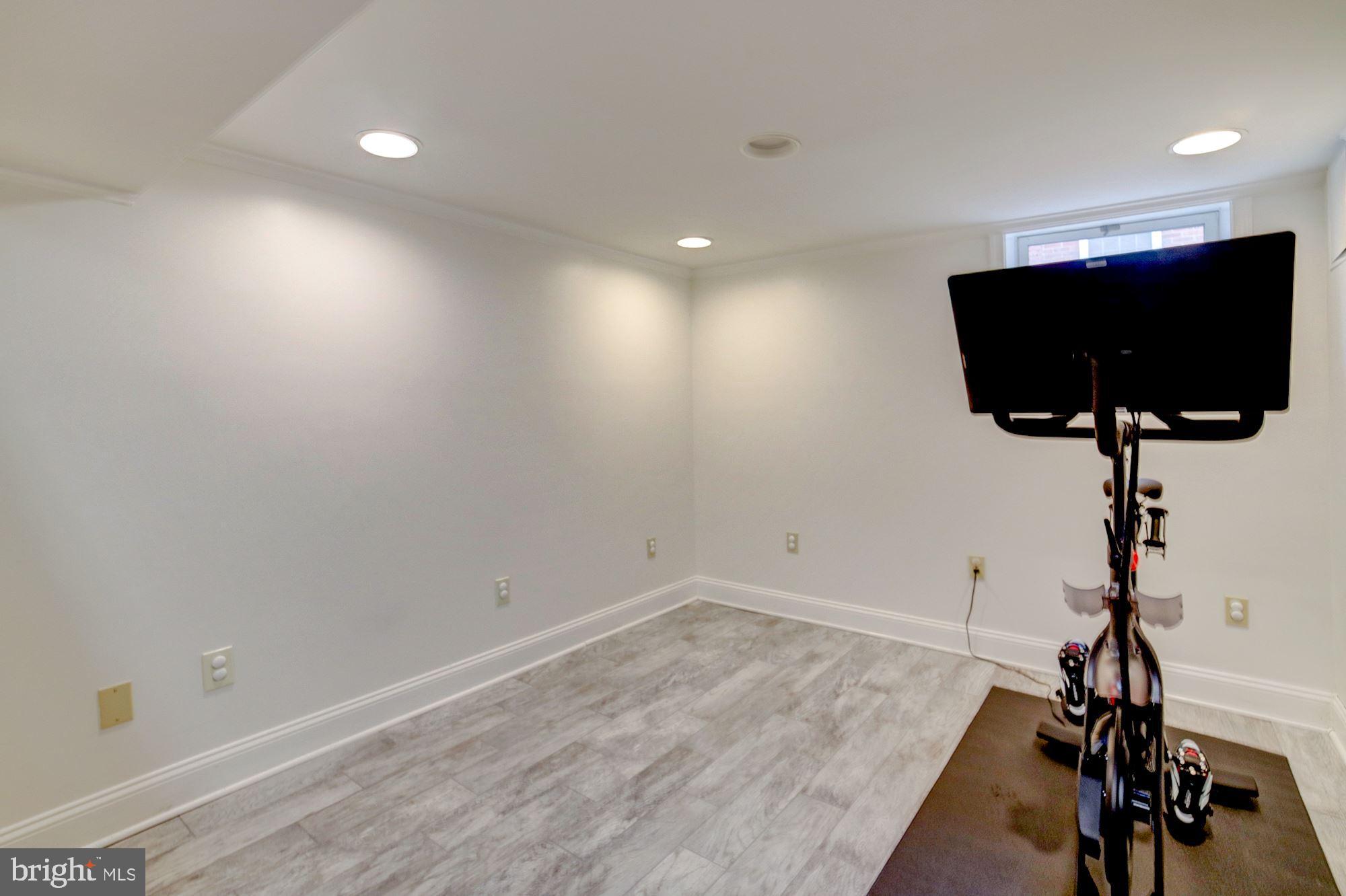 2510 Cameron Mills Road Alexandria, VA 22302 - Photo 22 of 32 Lower level game room w/porcelain wood-like floor
