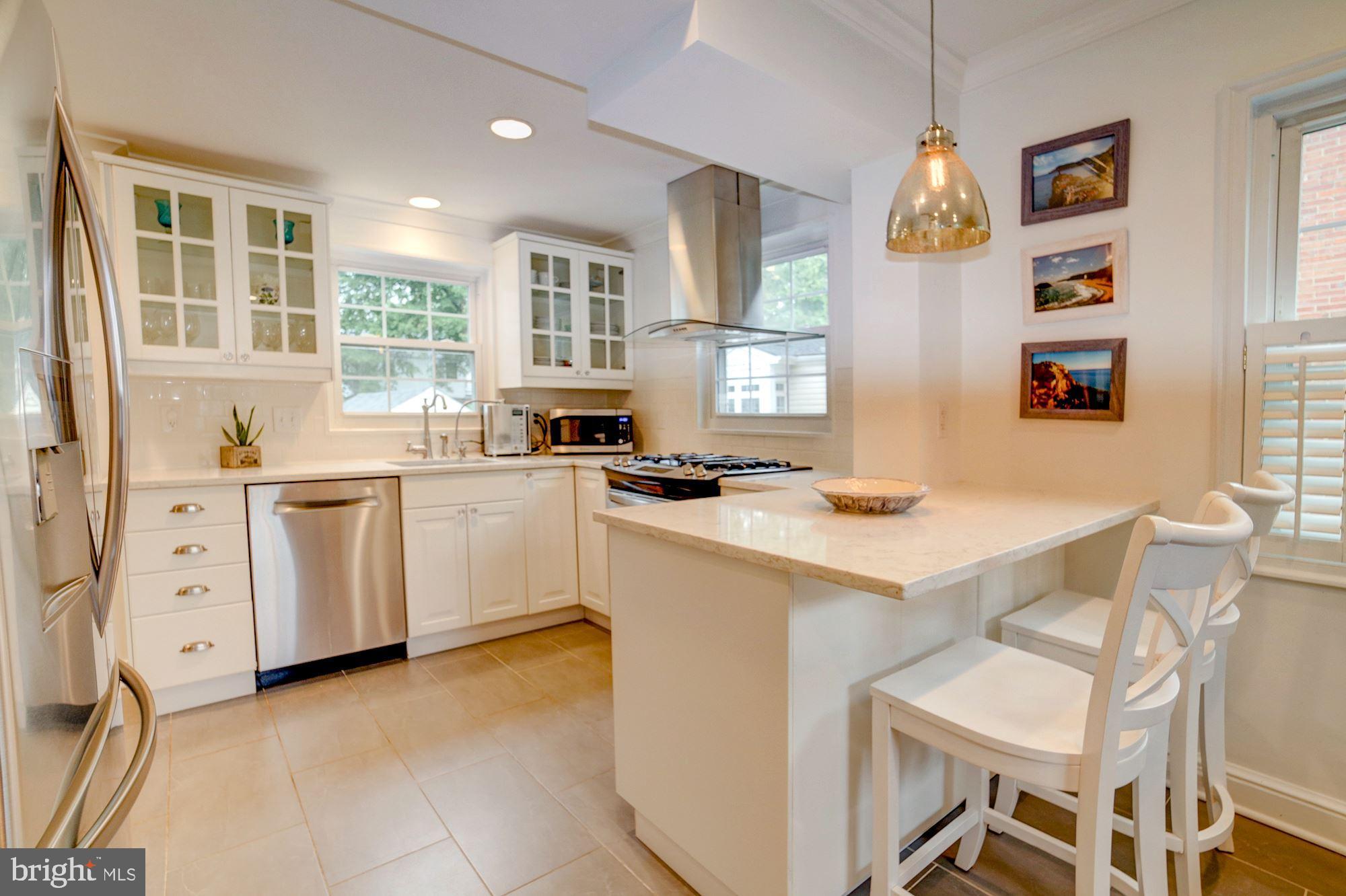 Quartz countertops, tile floor, lots of cabinets