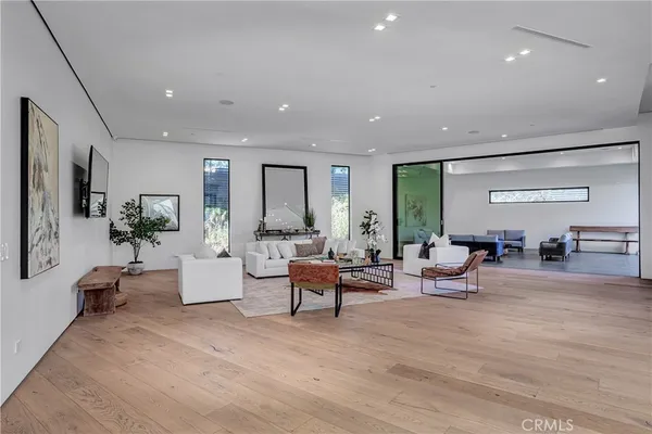 a spacious bedroom with a large bed and wooden floor